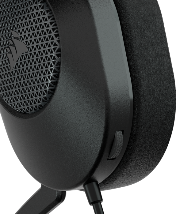 Close up of HS65 SURROUND wired gaming headset showing the volume wheel on the left ear cup. 